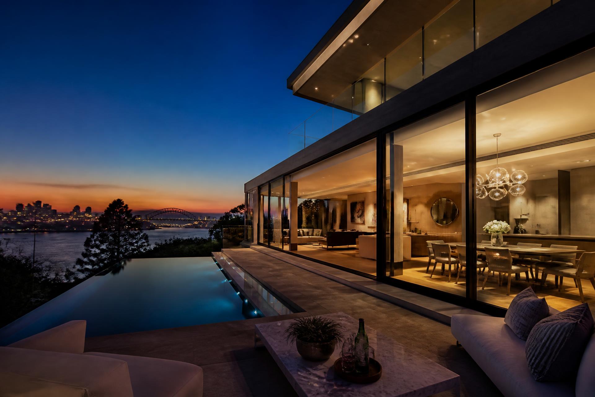 Luxury modern Sydney home at dusk overlooking the harbour